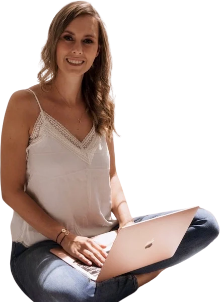 Jackie Lantzen sitting cross-legged with her laptop, smiling
