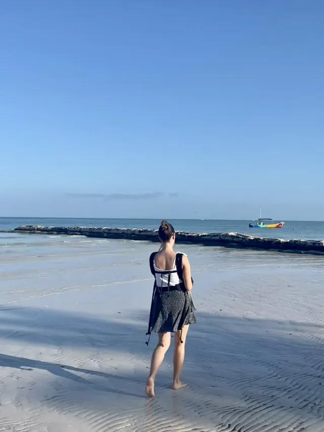 Jackie carrying her son on a Mexican beach
