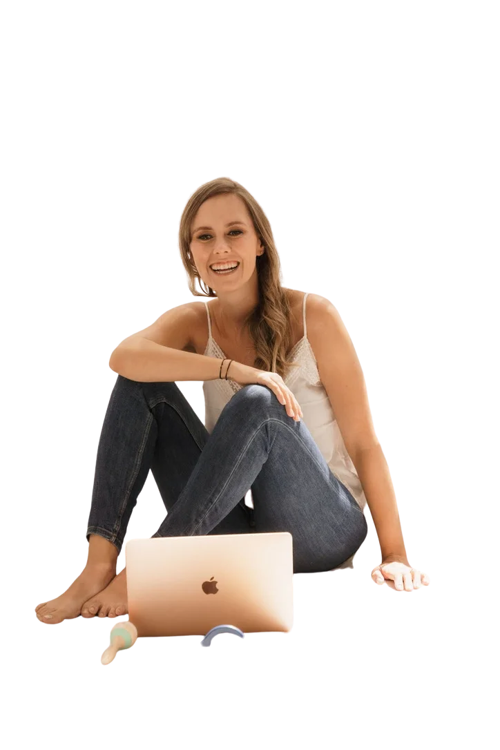 Jackie Lantzen sitting on the floor with her laptop, smiling